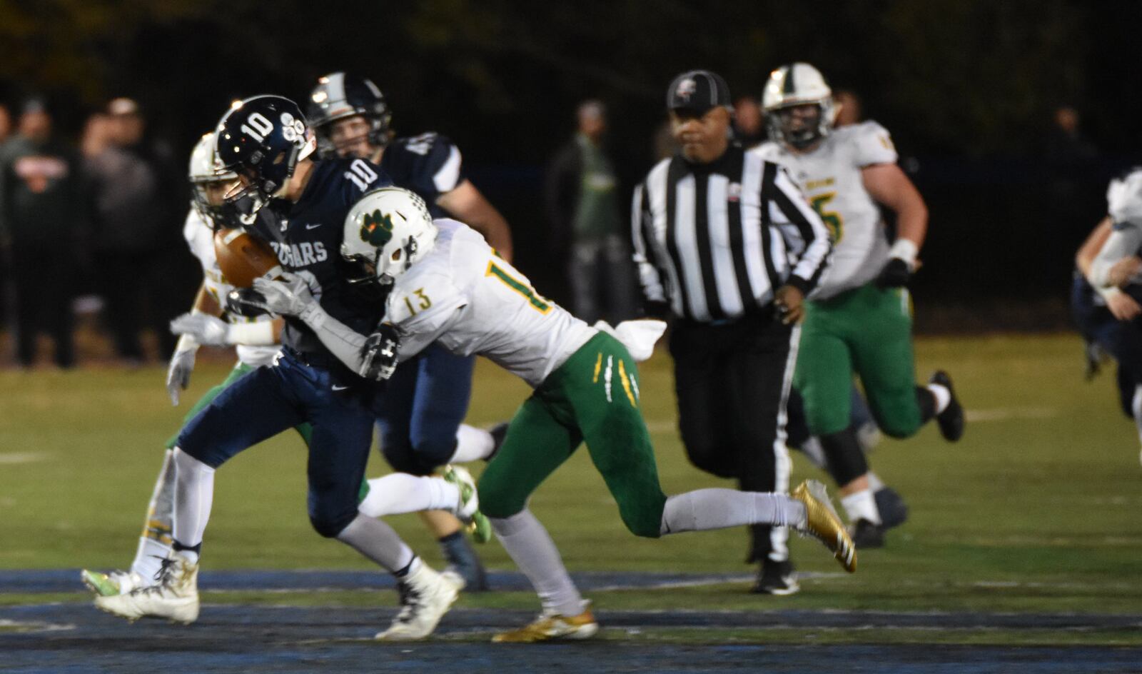 Little Miami’s Ryan Kerman (13) gets a grip on Edgewood’s Conner Beckman (10) during Friday night’s Division II, Region 8 playoff game at Kumler Field in St. Clair Township. Edgewood lost 10-7. CONTRIBUTED PHOTO BY DAWN JOSEPH