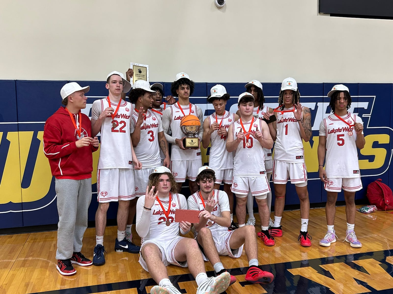 The Lakota West High School boys basketball team celebrates after winning a holiday tournament down in Miami, Florida, last week. CONTRIBUTED PHOTO