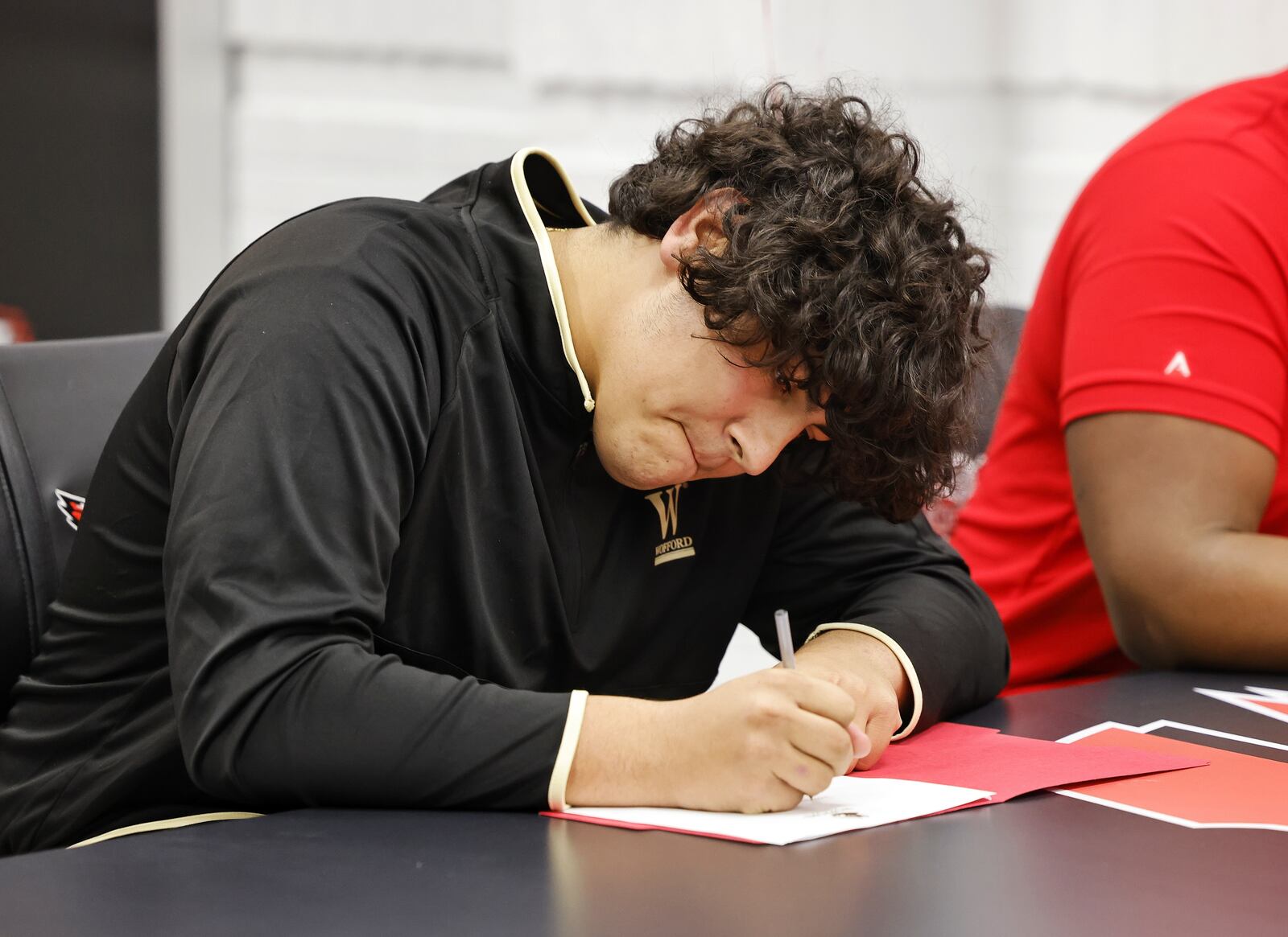 Lakota West's Latham McComis participates in a national letter of intent college football signing ceremony Wednesday, Dec. 15, 2021 at Lakota West High School. McComis is signing with Wofford College. NICK GRAHAM / STAFF