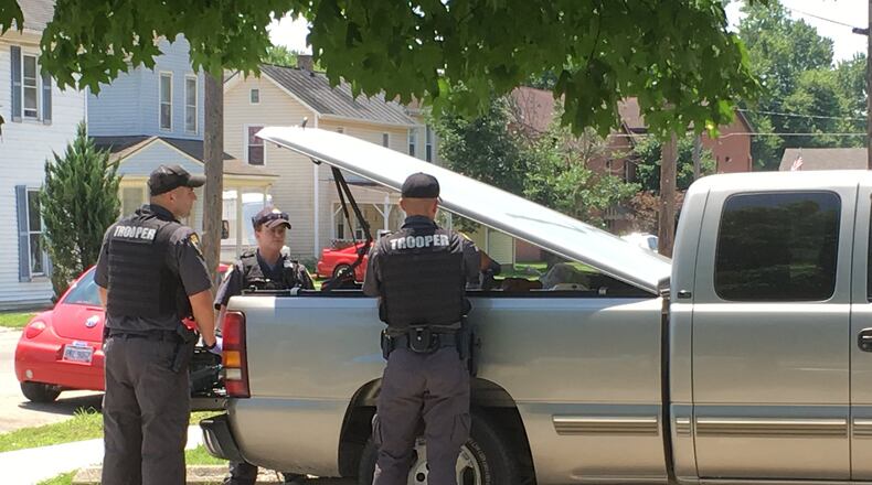 Members of the State Highway Patrol, part of the Warren County Task Force, search a vehicle that was parked near some apartments Friday afternoon on South River Street in Franklin. A person known to be involved with drugs was seen acting “suspicious,” according to Franklin police. RICK McCRABB/STAFF