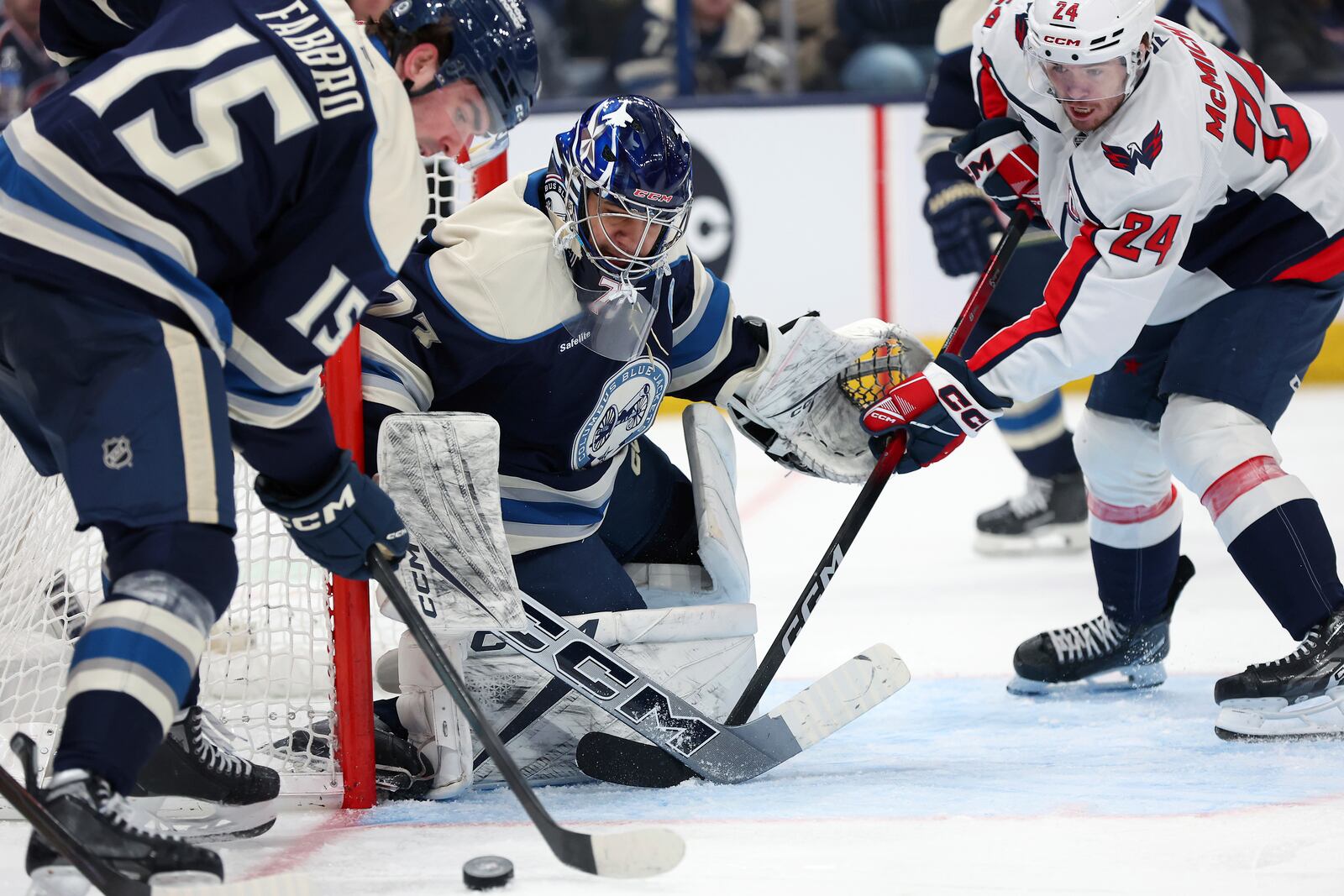 Columbus Blue Jackets goaltender Jet Greaves (73) saves a shot from Washington Capitals center Connor McMichael (24) during the third period of an NHL hockey game on Saturday, April 12, 2025, in Columbus, Ohio. (AP Photo/Joe Maiorana)