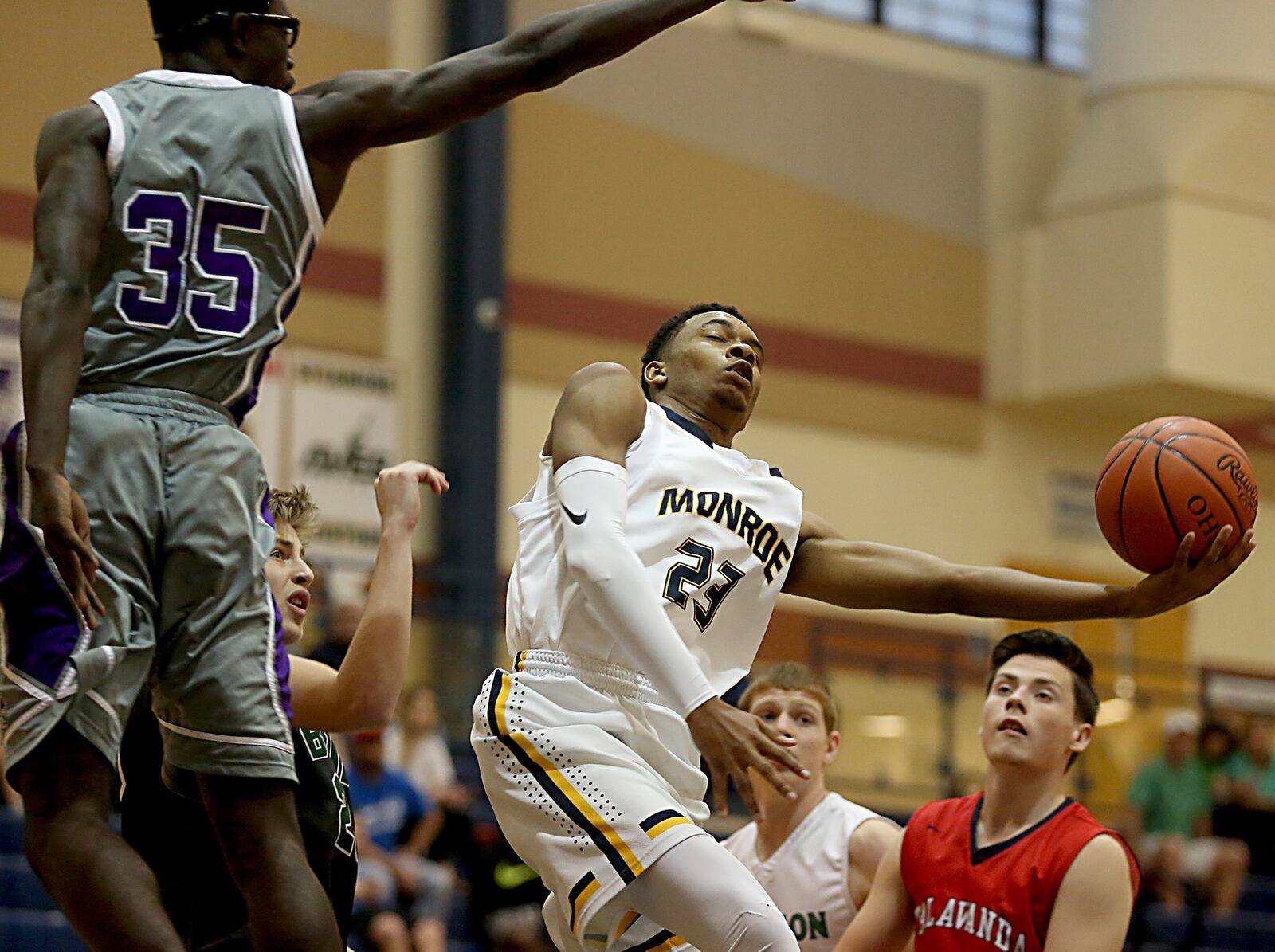 Monroe’s Tristan Backas manuevers for a shot between (from left) Middletown’s Jomar Bailey (35), Badin’s John Marot, Harrison’s Jacob Back and Talawanda’s Justin Boggs during the inaugural All-Butler County All-Star boys basketball game at the Hamilton Athletic Center on Saturday. CONTRIBUTED PHOTO BY E.L. HUBBARD