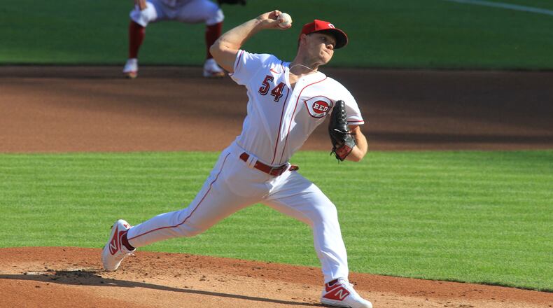 Reds starter Sonny Gray throws the first pitch of the season against the Tigers on Opening Day on Friday, July 24, 2020, at Great American Ball Park in Cincinnati. David Jablonski/Staff