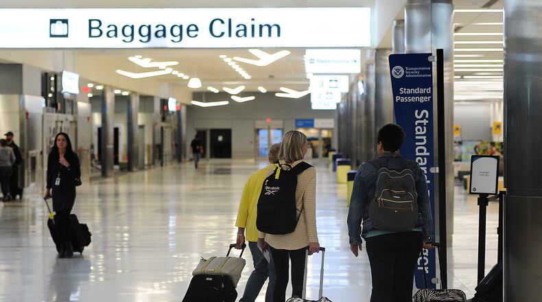 Travelers at the Dayton International Airport. MARSHALL GORBY\STAFF