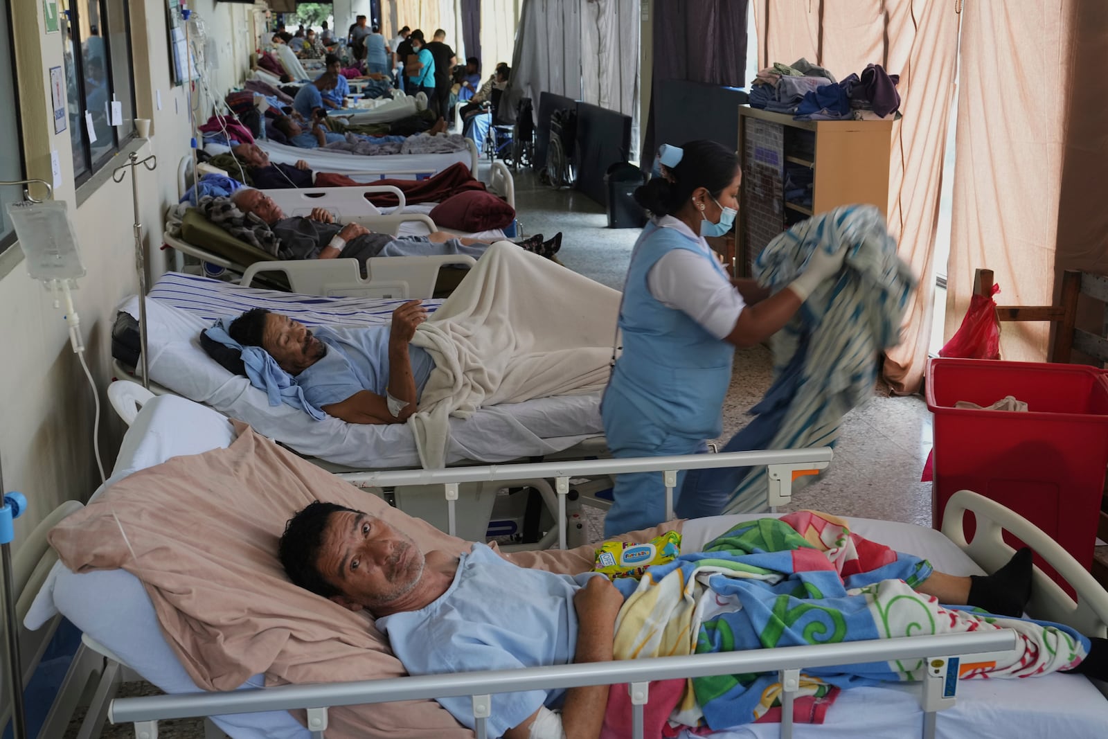 Patients are gathered in a safe area of "Hermano Pedro" Hospital after being relocated from other areas of the hospital in Antigua, Guatemala, Wednesday, July 9, 2025, following dozens of earthquakes and aftershocks were recorded in a matter of hours. (AP Photo/Moises Castillo)