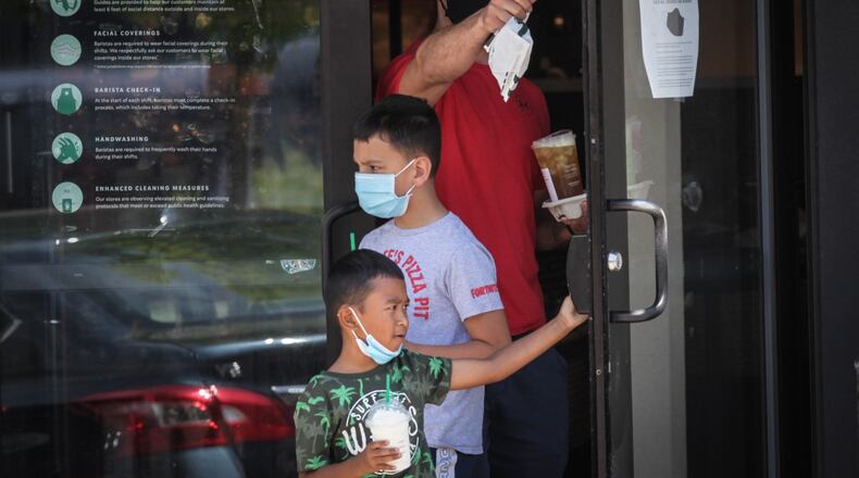 Many large retailers are now requiring that customers join their employees in wearing face masks to stop the spread of the coronavirus. Starbucks, Best Buy and Kroger have also announced mandatory masks nationwide in recent days. Starbucks and Best Buy started requiring that customers wear masks on July 15. Most people who entered the Starbucks on Far Hills Ave. in Oakwood were wearing masks. JIM NOELKER/STAFF