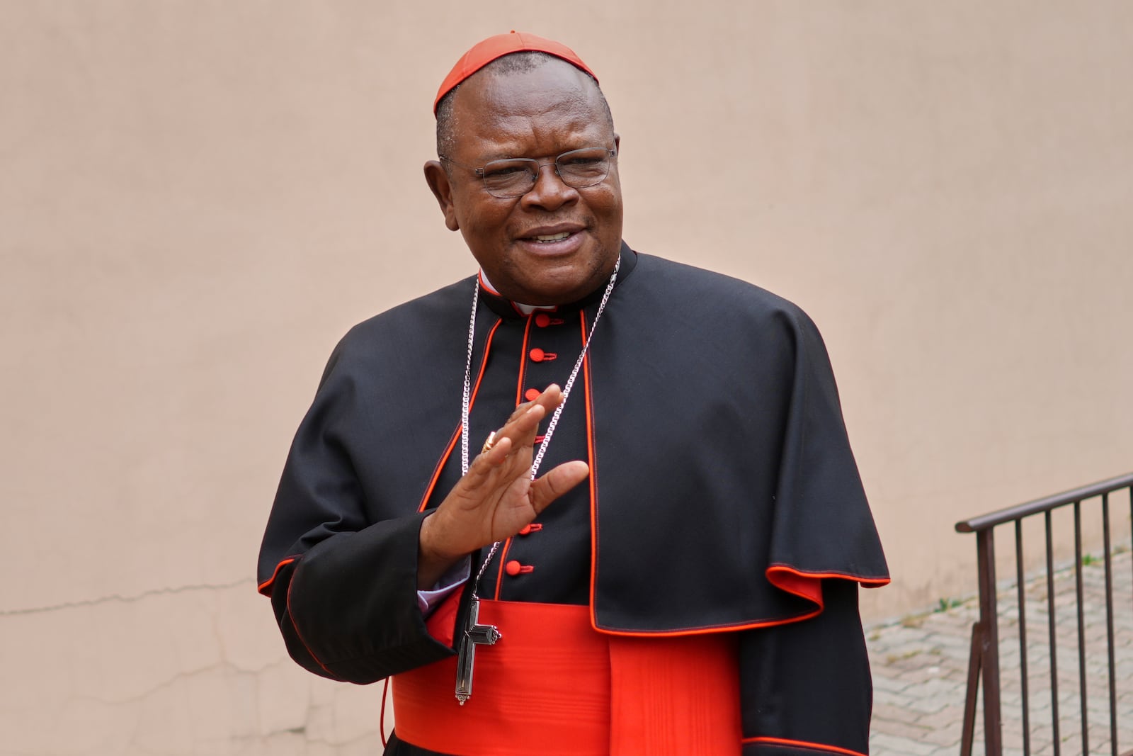Cardinal Fridolin Ambongo Besungu arrives to celebrate Mass at his titular church, San Gabriele Arcangelo all'Acqua Traversa three days before the conclave to elect the 267th pope of the Roman Catholic Church, in Rome, Sunday, May 4, 2025. (AP Photo/Andrew Medichini)