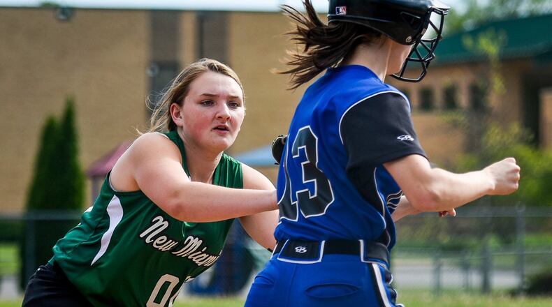 New Miami’s Kristyn Riley tags out Cincinnati Christian’s Jessica Fornshell on the way to first base during their softball game April 24, 2017, at New Miami. CCS won 22-14. NICK GRAHAM/STAFF