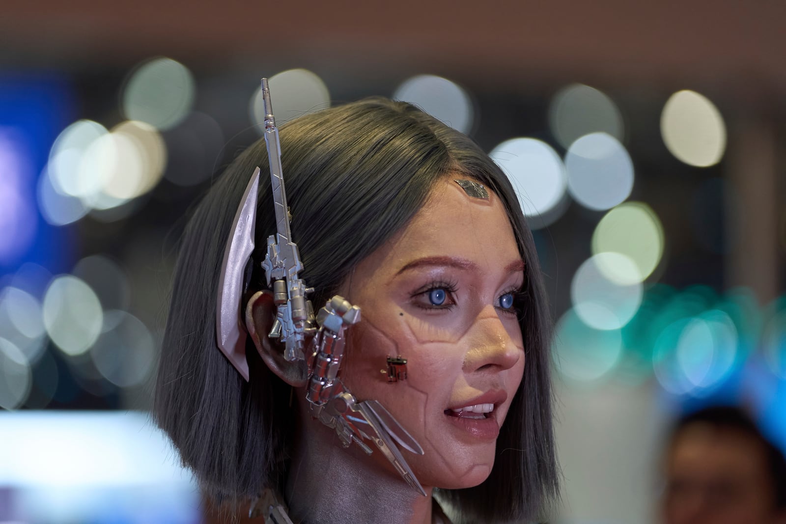 A vlogger who dressed up to look like a humanoid robot reacts at the Shanghai auto show on Thursday, April 24, 2025. (AP Photo/Ng Han Guan)