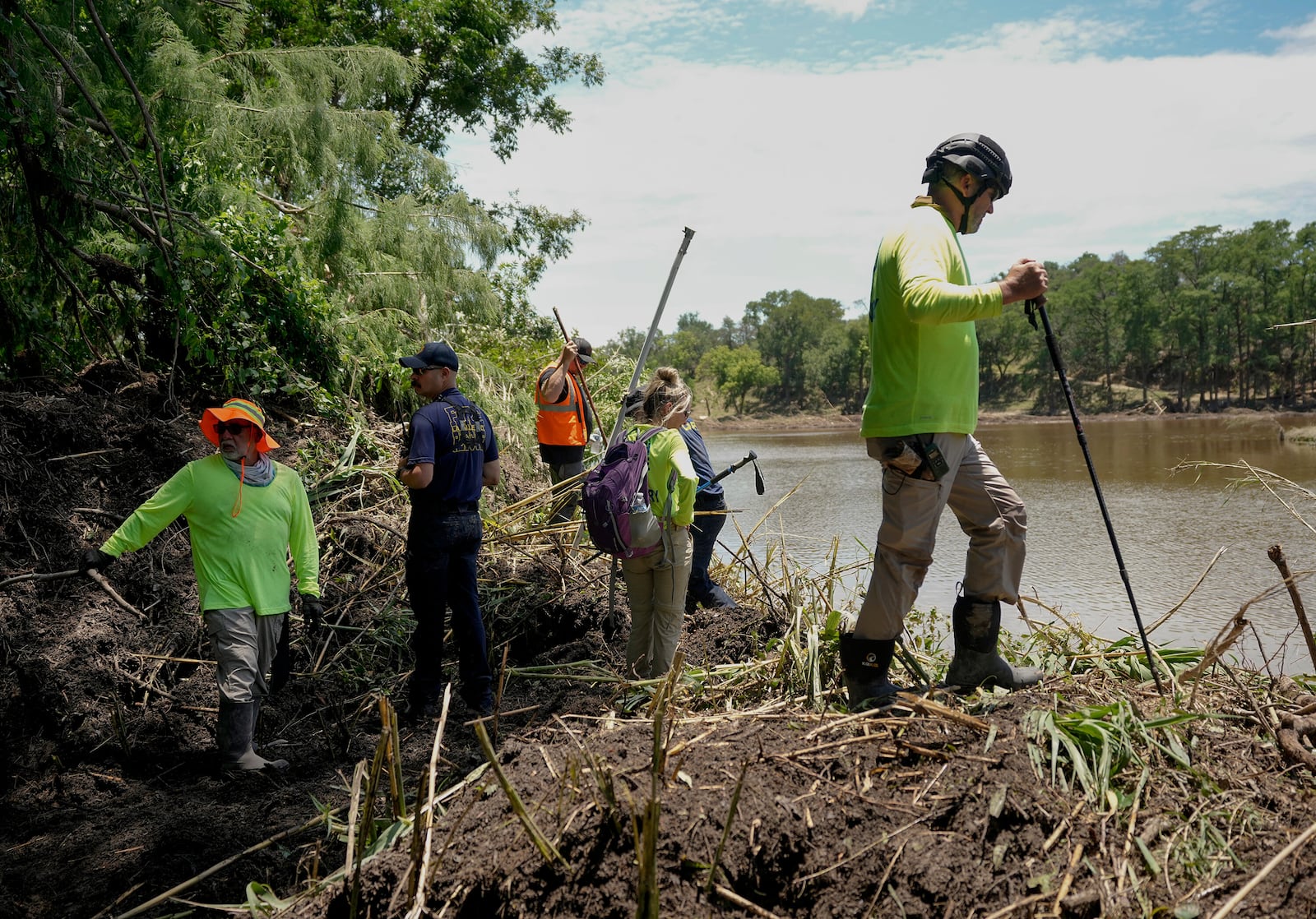 Eric Herr, a volunteer with Search and Support San Antonio, does search and rescue work on the banks of the Guadalupe River in Ingram, Texas, Tuesday, July 8, 2025, after the Fourth of July flood. (Jay Janner/Austin American-Statesman via AP)