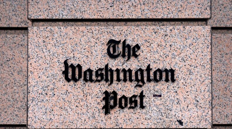 A sign for the Washington Post is seen at the company's offices, Monday, Jan. 26, 2026, in Washington. (AP Photo/Mark Schiefelbein)