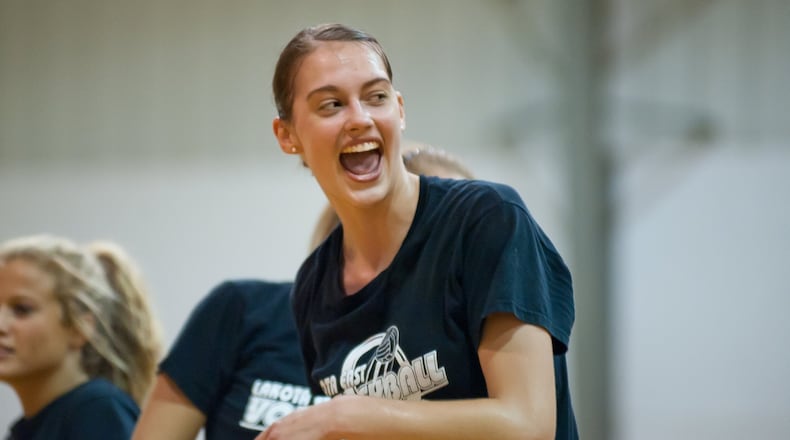 Lakota East’s Ashley Evans celebrates a point during a scrimmage against St. Ursula on Aug. 23, 2011. COX MEDIA FILE PHOTO