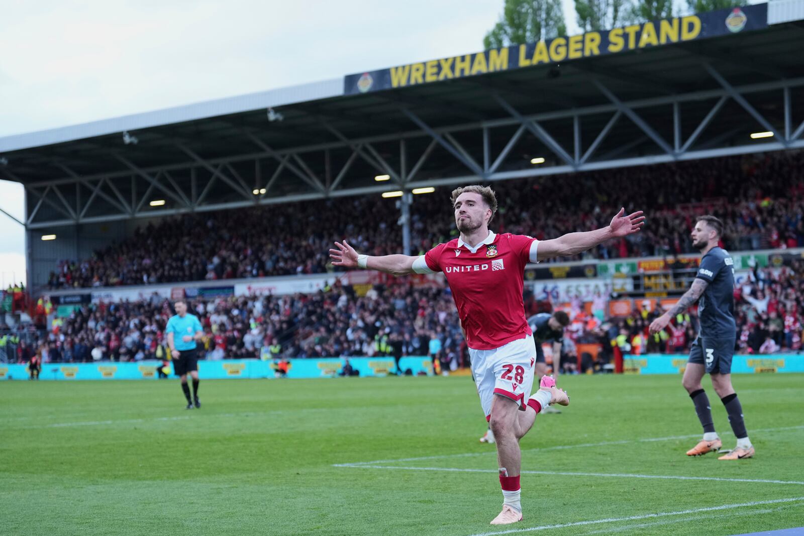 Wrexham's Sam Smith celebrates after scoring his side's third goal during the English League One soccer match between Wrexham and Charlton Athletic at the Racecourse ground in Wrexham, Wales, Saturday, April 26, 2025. (AP Photo/Jon Super)