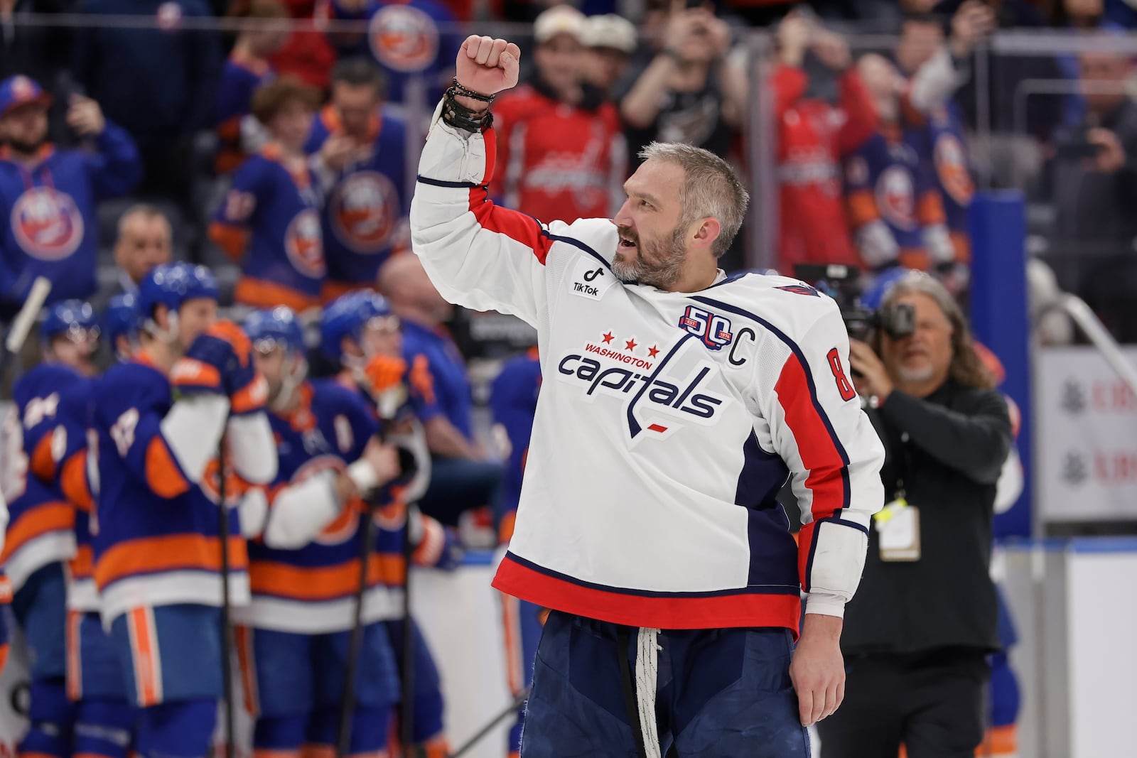 Washington Capitals left wing Alex Ovechkin (8) celebrates after scoring his 895th career goal during the second period of an NHL hockey game against New York Islanders in Elmont, N.Y., Sunday, April 6, 2025. (AP Photo/Adam Hunger)