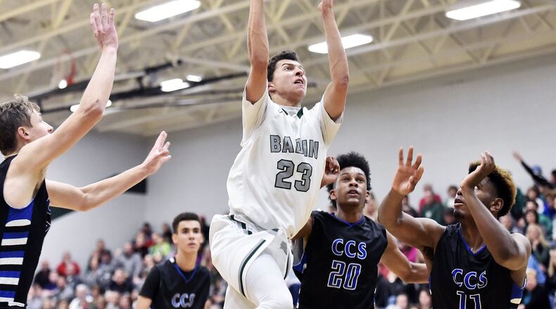 Badin’s Caleb Meyer cuts through the Cincinnati Christian defense, including Wayne Lavender (11) and Miguel Ringer (20), during Friday night’s game at Mulchaey Gym in Hamilton. NICK GRAHAM/STAFF