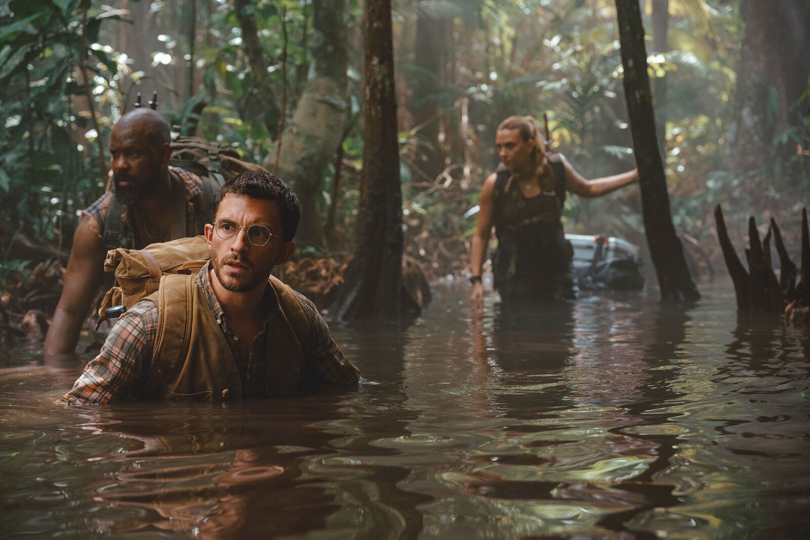 This image released by Universal Pictures and Amblin Entertainment shows, from left, Bechir Sylvain, Jonathan Bailey, and Scarlett Johansson in a scene from " Jurassic World Rebirth." (Jasin Boland/Universal Pictures and Amblin Entertainment via AP)