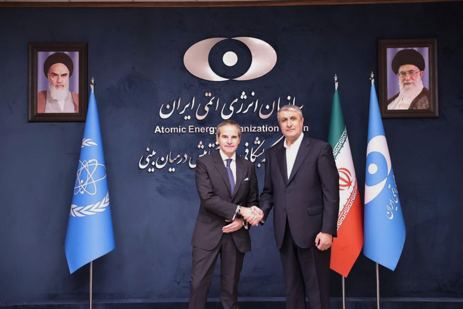 In this photo released by the Atomic Energy Organisation of Iran, International Atomic Energy Agency (IAEA) Director General, Rafael Mariano Grossi, left, shakes hands with head of the Atomic Energy Organization of Iran Mohammad Eslami, at the Atomic Energy Organisation of Iran, in Tehran, Iran, Thursday, April 17, 2025. (Atomic Energy Organisation of Iran via AP)