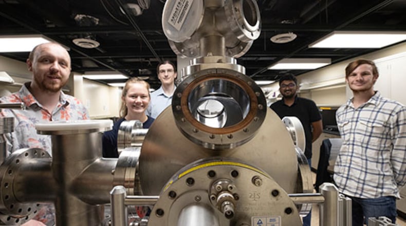 Perry Corbett, assistant professor of Physics, left, stands with students Sara McGinnis, Carter Wade, Lakshan Don Manuwelge Don and Nate Price around the newly donated ultra-high vacuum scanning tunneling microscope. PHOTO: JEFF SABO/CONTRIBUTED