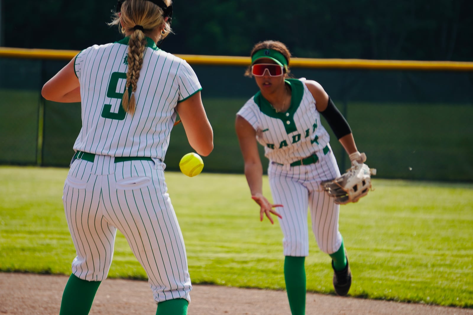 Badin junior second baseman Kira Rohan makes a play to Ella Kent at first base during their Division III tournament game against Goshen on Thursday at Mueller Stadium. CHRIS VOGT / CONTRIBUTED