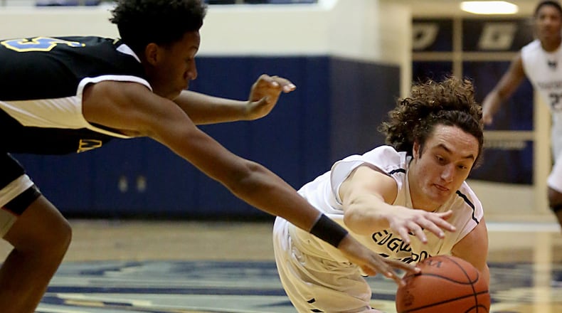 Edgewood guard Garrett Gabbard (right) and Northwest guard Jamique Dogan dive for a loose ball during their game at Ron Kash Court in Trenton on Jan. 14, 2017. COX MEDIA FILE PHOTO