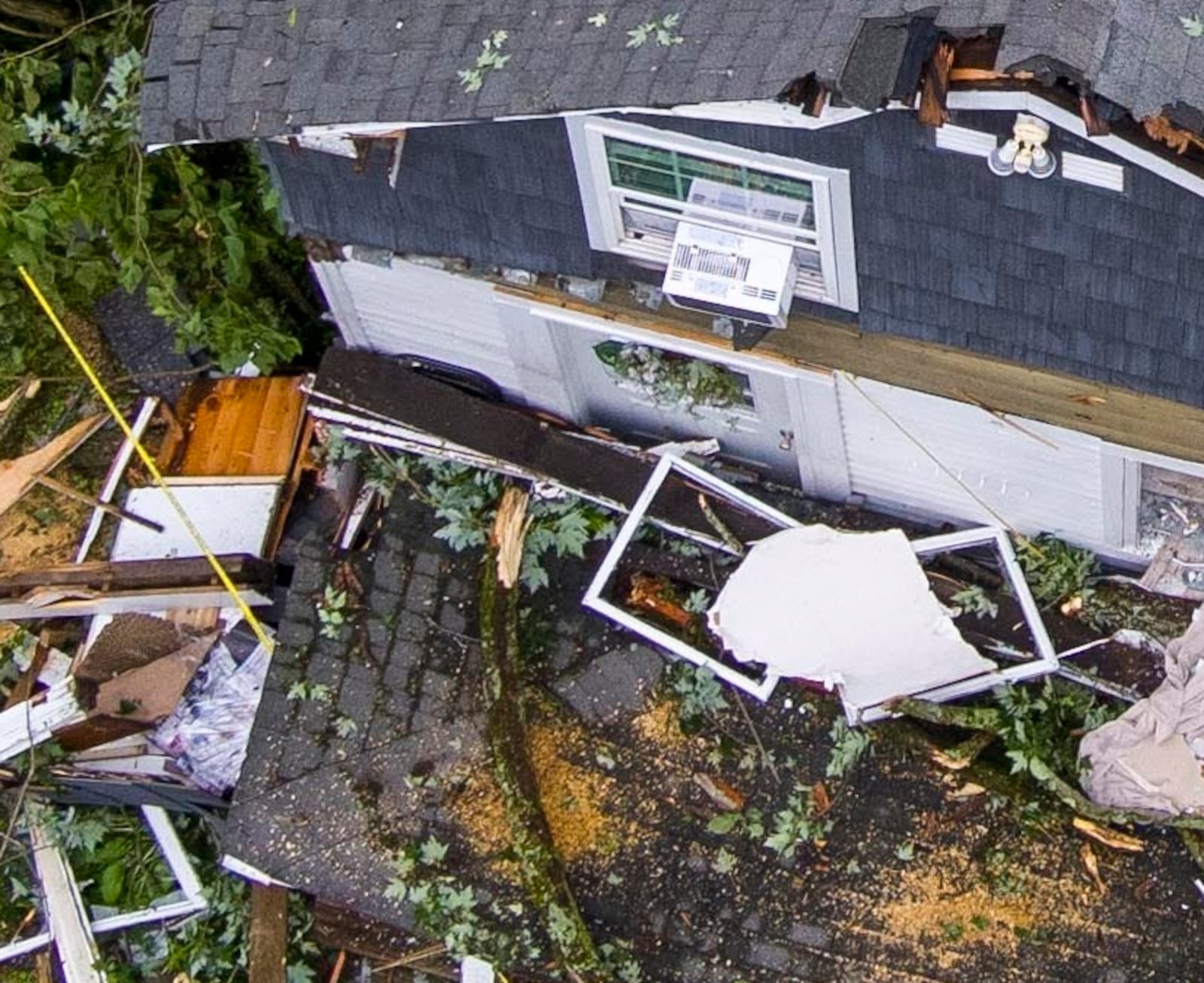 Two young girls were killed when a tree fell through the house as a devastating storm passed through, Sunday, June 22, 2025, in Clark Mills, N.Y. (N. Scott Trimble/The Post-Standard via AP)