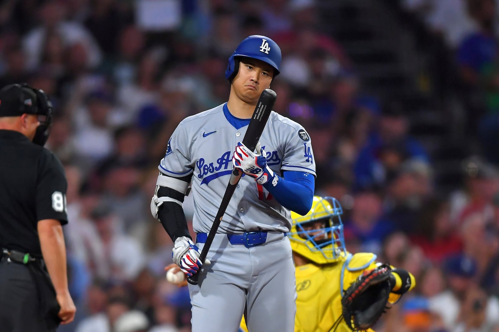 Los Angeles Dodgers' Shohei Ohtani examines his bat before striking out in the fourth inning of a baseball game against the Boston Red Sox, Saturday, July 26, 2025, in Boston. (AP Photo/Steven Senne)