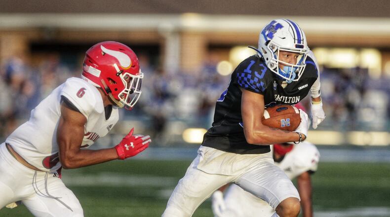 Hamilton wide receiver Daryan Bowling looks to outrun Princeton safety Leroy Bowers during their season-opening game at Virgil Schwarm Stadium on Aug. 28, 2020. Nick Graham/STAFF