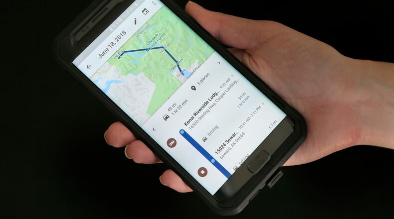 FILE - In this Aug. 8, 2018, file photo, a mobile phone displays a user's travels using Google Maps in New York. (AP Photo/Seth Wenig, File)