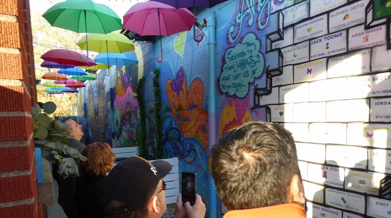 Families, friends and neighbors of Mason children gone too soon gathered on Oct. 28 for a dedication ceremony and ribbon-cutting of Angel Alley, a memorial to those preschool through college age residents who have passed away. JON WEIDLICH/CONTRIBUTOR