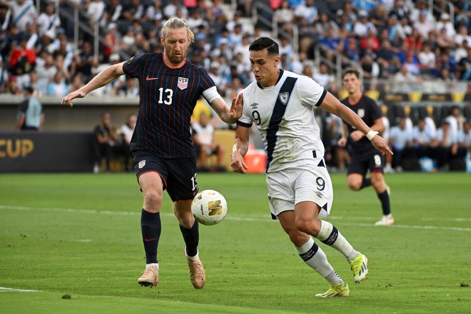 United States defender Timo Ream (13) and Guatemala forward Rubio Mendez (9) chase a loose ball during the second half of a CONCACAF Gold Cup semifinal soccer match, Wednesday, July 2, 2025, in St. Louis. (AP Photo/Connor Hamilton)