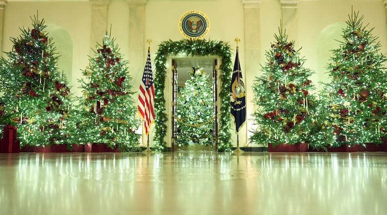 Christmas trees decorate the Cross Hall of the White House during a press preview of the Christmas decorations "Home is Where the Heart Is," Monday, Dec. 1, 2025, in Washington. (AP Photo/Evan Vucci)