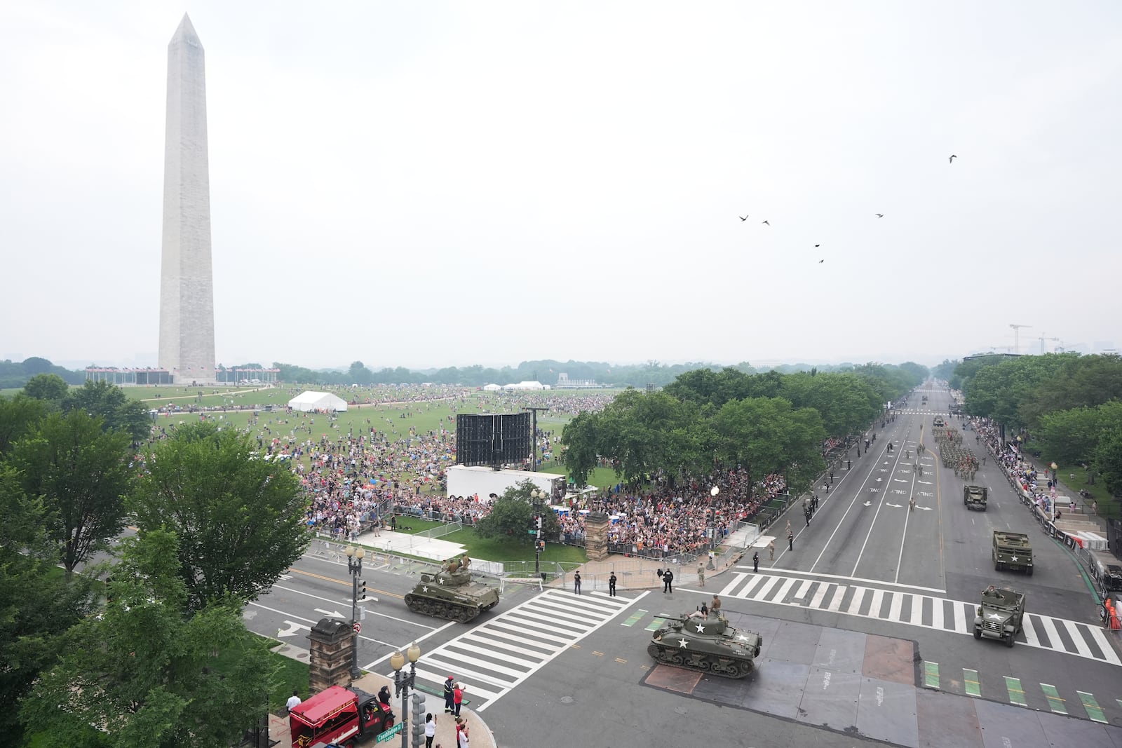 A military parade commemorating the Army's 250th anniversary and coinciding with President Donald Trump's 79th birthday, Saturday, June 14, 2025, in Washington. The Washington Monument stands left. (AP Photo/Jacquelyn Martin)