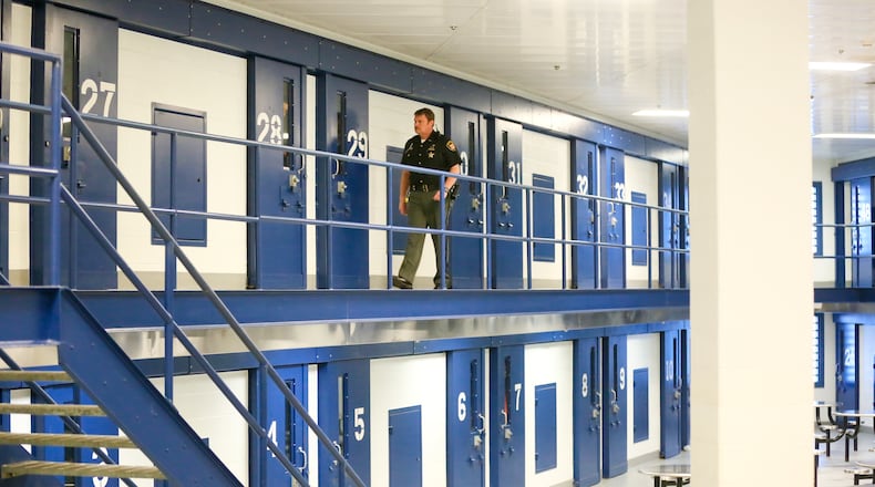 Butler County officials settled a federal lawsuit brought by the daughter of a woman who died at the jail in 2012. Here, a Butler County Corrections officer checks the cells in the Butler County Correctional Center in 2015. GREG LYNCH / STAFF