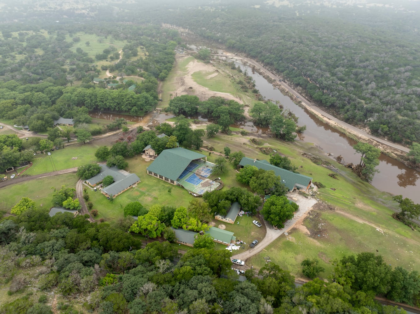 A damaged hall at Camp Mystic on the South Fork Guadalupe River, right, and Cypress Creek, center,in Hunt, Texas, on Saturday, July 5, 2025. (Carter Johnston/The New York Times)