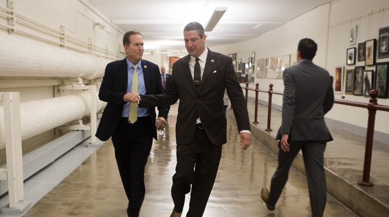 Reps. Tim Ryan, D-Ohio, right, and Vern Buchanan, R-Fla., head to a news conference on Capitol Hill in Washington, Nov. 17, 2016. Ryan is challenging House Minority Leader Nancy Pelosi, D-Calif., for her position in upcoming party elections. (Stephen Crowley/The New York Times)