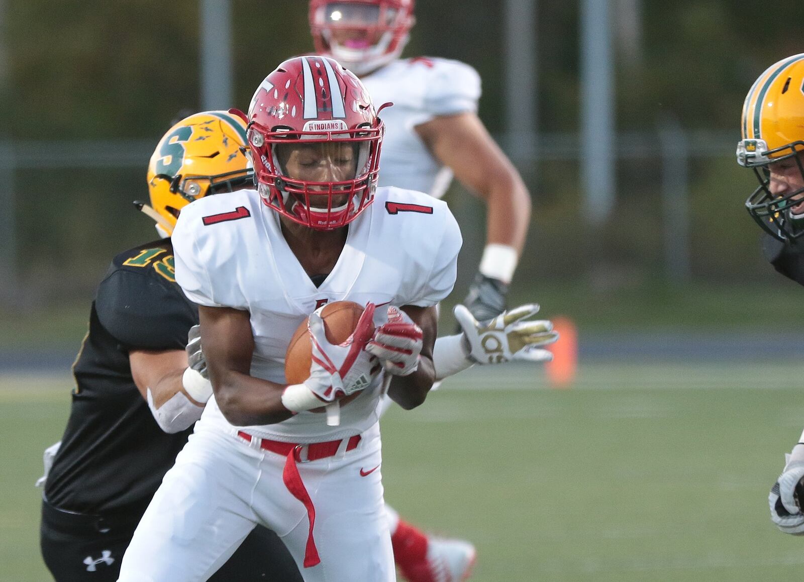 Fairfield’s Chico Robinson (1) tries to get away from Sycamore’s Patrick Tueimeh (19) during Thursday night’s game at Coach Bud Acus Alumni Field at Sycamore Stadium. CONTRIBUTED PHOTO BY TONY TRIBBLE/WCPO.COM