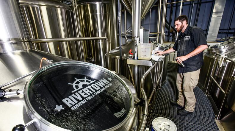 Brewer Charles Taylor tends to the brewing process at Rivertown Brewery & Barrel House Wednesday, June 14 in Monroe. NICK GRAHAM/STAFF