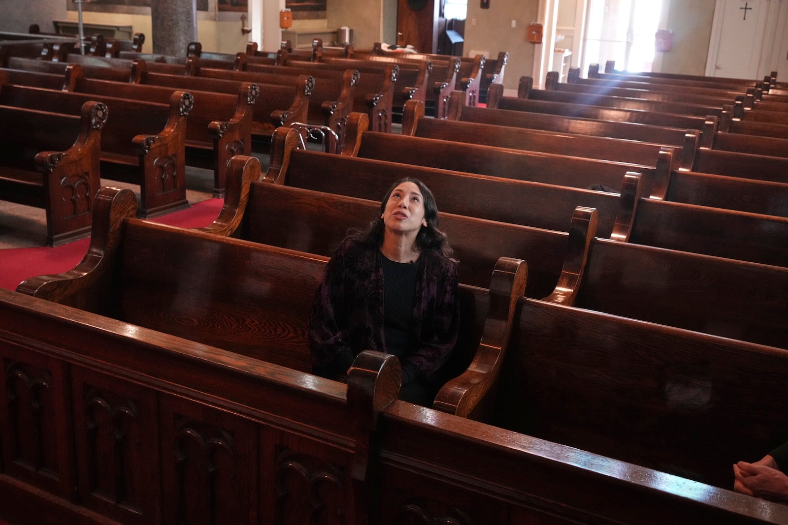 Art conservator Naomi Ruiz looks at murals by Croatian-American artist Maxo Vanka in St. Nicholas Croatian Catholic Church in Millvale, Pa., Jan. 21, 2025. (AP Photo/Gene J. Puskar
