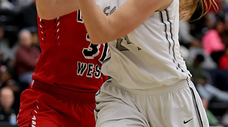 Lakota East forward Bryn Mangold shoots while being covered by Lakota West forward Nevaeh Dean during their game in Liberty Township on Dec. 14, 2016. CONTRIBUTED PHOTO BY E.L. HUBBARD