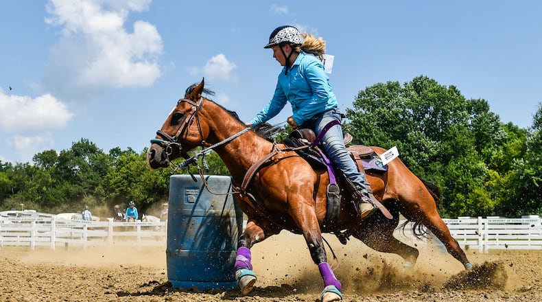 Sydney Staley, 12,  rides her horse, Chatter, during barrel racing Wednesday, July 25 at the Butler County Fair in Hamilton. NICK GRAHAM/STAFF