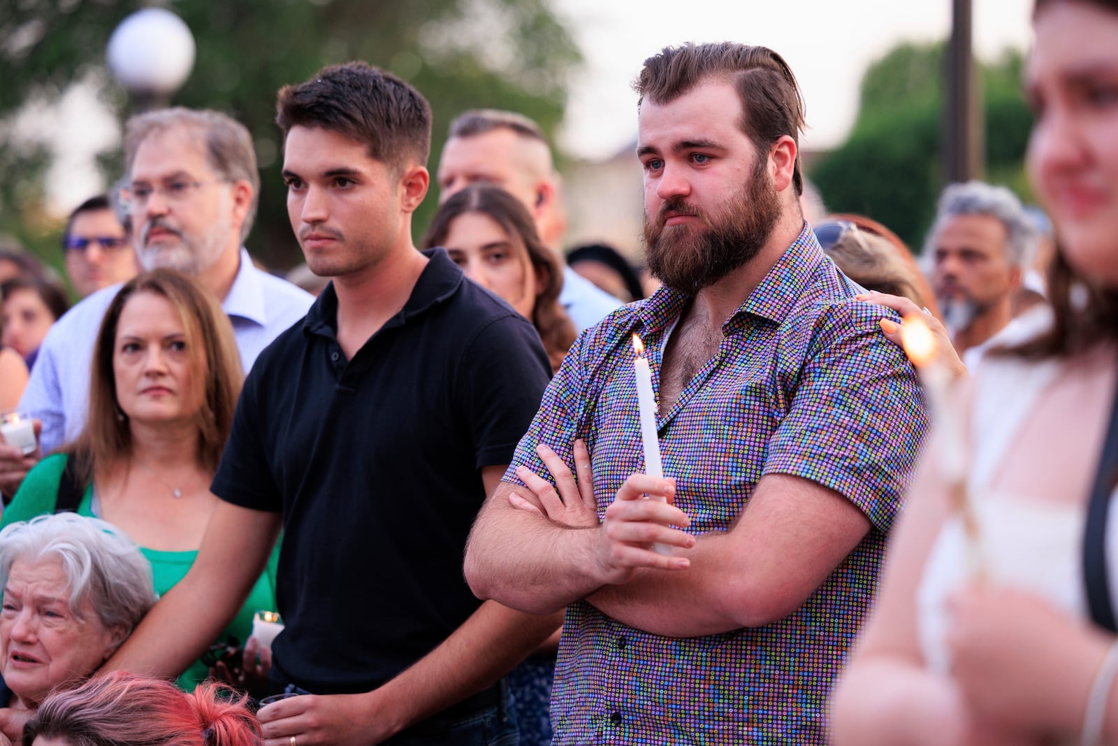 Colin Hortman, right, attends a candlelight vigil for his parents, former House Speaker Melissa Hortman and her husband Mark, who were fatally shot, at the state Capitol, Wednesday, June 18, 2025, in St. Paul, Minn. (AP Photo/Nikolas Liepins)