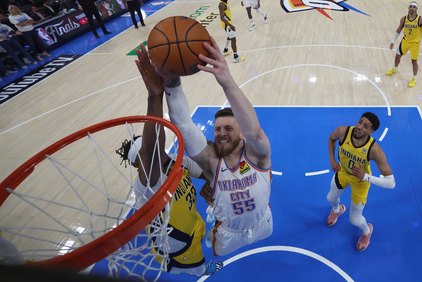 Oklahoma City Thunder center Isaiah Hartenstein (55) dunks over Indiana Pacers center Myles Turner (33) during the second half of Game 5 of the NBA Finals basketball series, Monday, June 16, 2025, in Indianapolis. (Matthew Stockman/Pool Photo via AP)