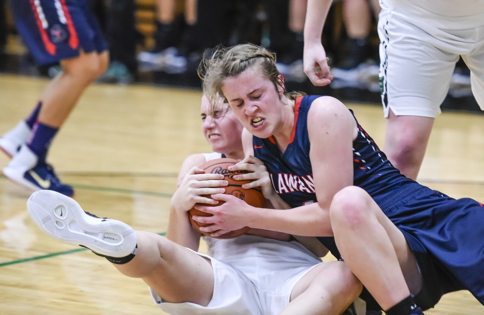 Badin’s Lauren Krause (left) and Talawanda’s Emma Wright fight for a loose ball during Monday night’s game at Mulcahey Gym in Hamilton. NICK GRAHAM/STAFF