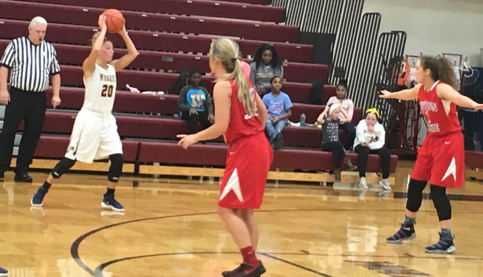 Monroe’s Erica Thompson (20) looks for an open teammate as Clinton-Massie’s Faith Cottrell (12) and Johanna Theetge (12) play defense during Thursday nights Division II sectional game at Lebanon. RICK CASSANO/STAFF