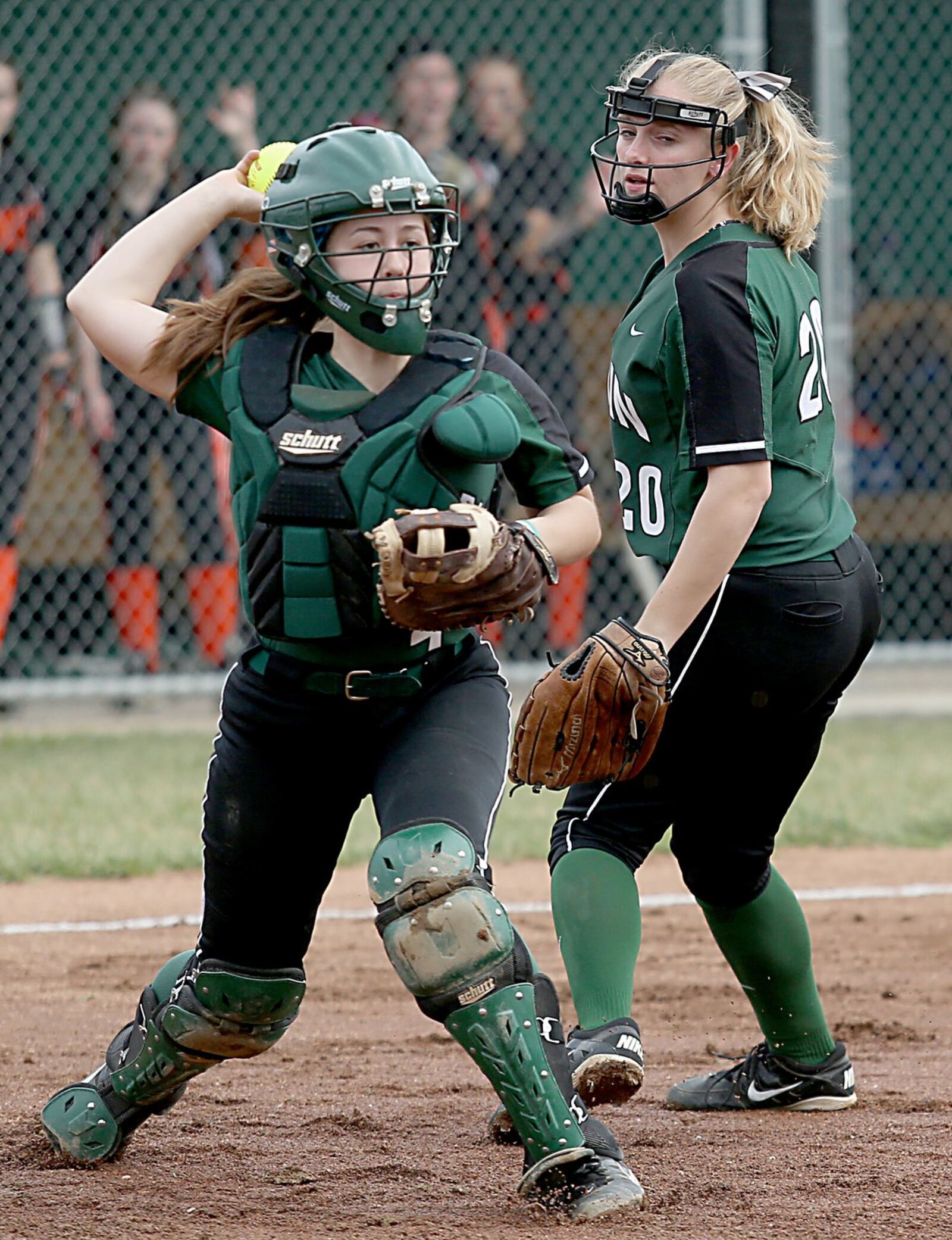 Badin catcher Lauren Moser fields a Wilmington bunt and makes a throw as first baseman Samantha Sander watches during Monday’s game at Mueller Stadium in Hamilton. CONTRIBUTED PHOTO BY E.L. HUBBARD