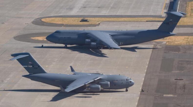 A US Air Force C-5 Galaxy and a C-17 Globemaster sit on the tarmac at Travis Air Force Base in Fairfield, California, on July 17, 2008. AFP PHOTO / SAUL LOEB (Photo credit should read SAUL LOEB/AFP/Getty Images)