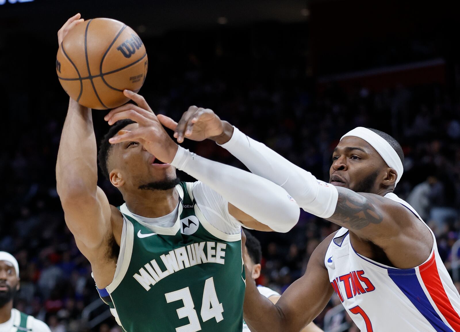 Milwaukee Bucks forward Giannis Antetokounmpo (34) is fouled by Detroit Pistons forward Paul Reed (7) while trying to take a shot during the first half of an NBA basketball game Friday, April 11, 2025, in Detroit. (AP Photo/Duane Burleson)