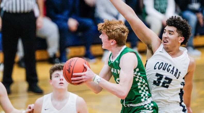 Edgewood’s Isaiah Gambrell tries to defend a shot by Badin’s Zach Switzer during their basketball game Dec. 28, 2018, at Edgewood. Badin won 49-46. NICK GRAHAM/STAFF