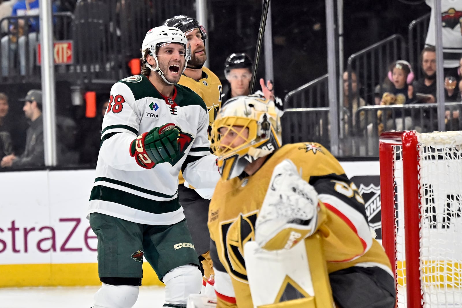 Minnesota Wild right wing Ryan Hartman (38) reacts after a goal by left wing Kirill Kaprizov against Vegas Golden Knights goaltender Adin Hill (33) during the first period of Game 5 of a first-round NHL hockey playoff series Tuesday, April 29, 2025, in Las Vegas. (AP Photo/David Becker)
