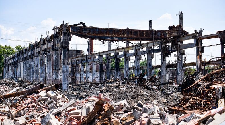Crews from Vickers Demolition work to dismantle what is left a week after a massive warehouse fire on Laurel Avenue Wednesday, July 31 in Hamilton. The fire started just before 5 a.m. Thursday, July 25, 2019. NICK GRAHAM / STAFF